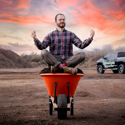 woodrow meditating on a wheelbarrow full of mulch