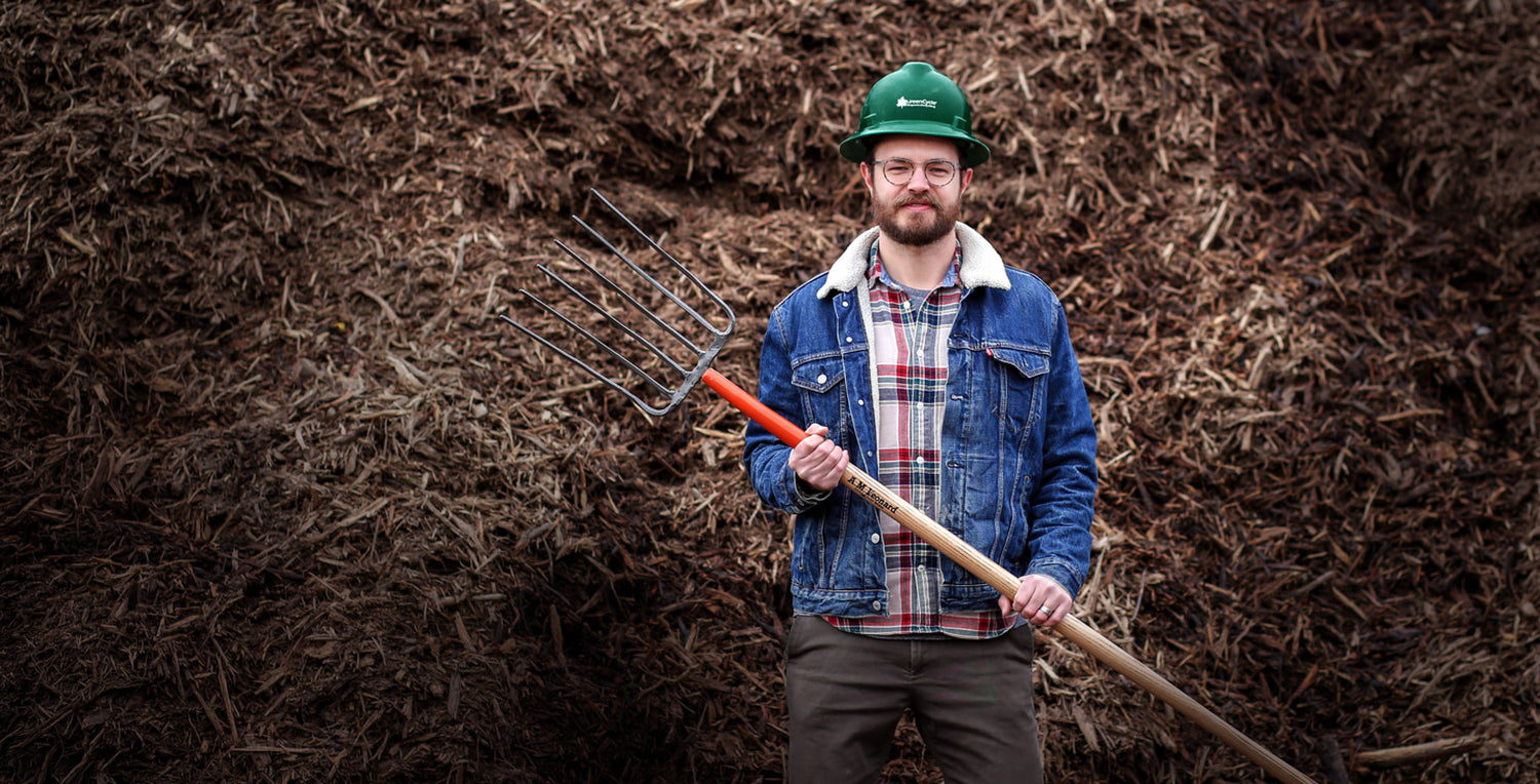 woodrow standing in front of a giant mulch pile