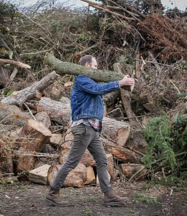 man carrying yard waste for recycling