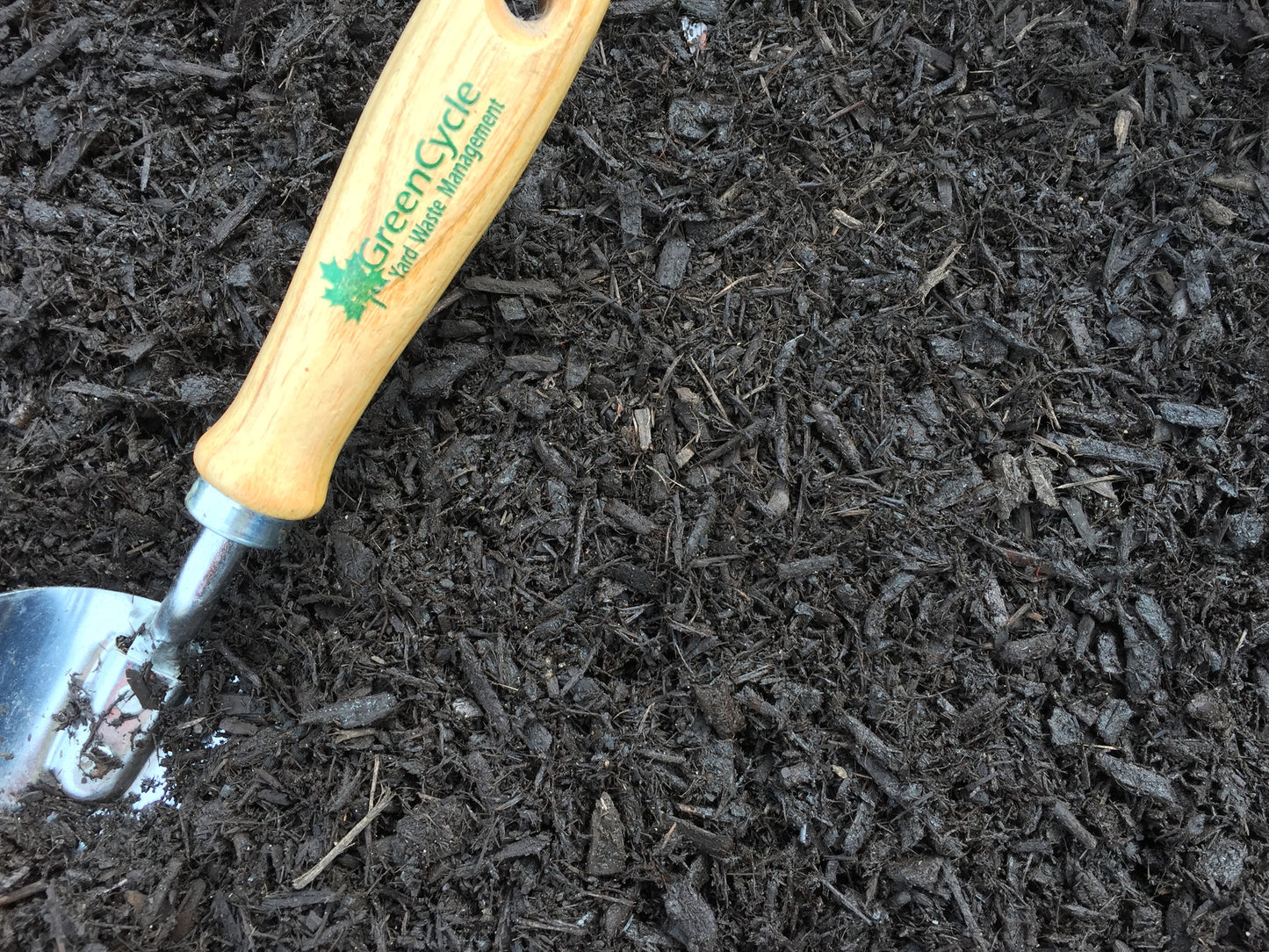 fine grind brown dyed mulch with spade